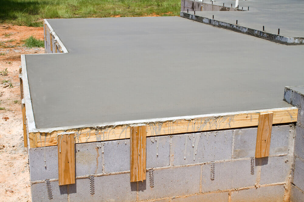 One of our freshly poured concrete slabs that is being held together by wooden borders